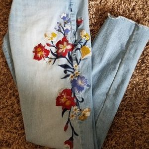 Light wash floral embroidered skinny jeans.